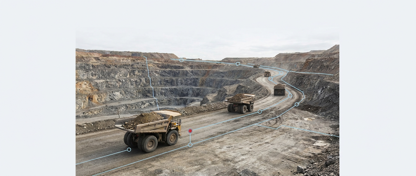 Haul trucks moving along a mine pit road between operating zones